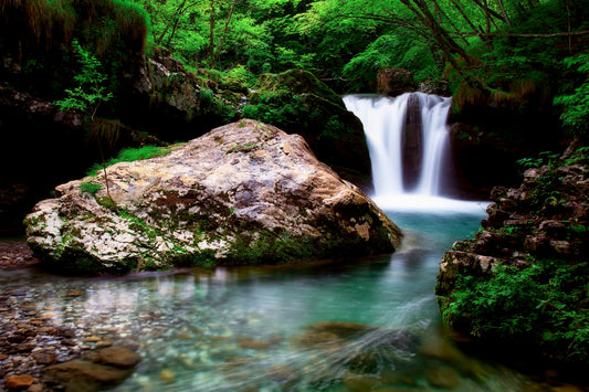 The Calmness of the 1920s Forest: A Green and White Waterfall and Rock Piece in Americana Style
